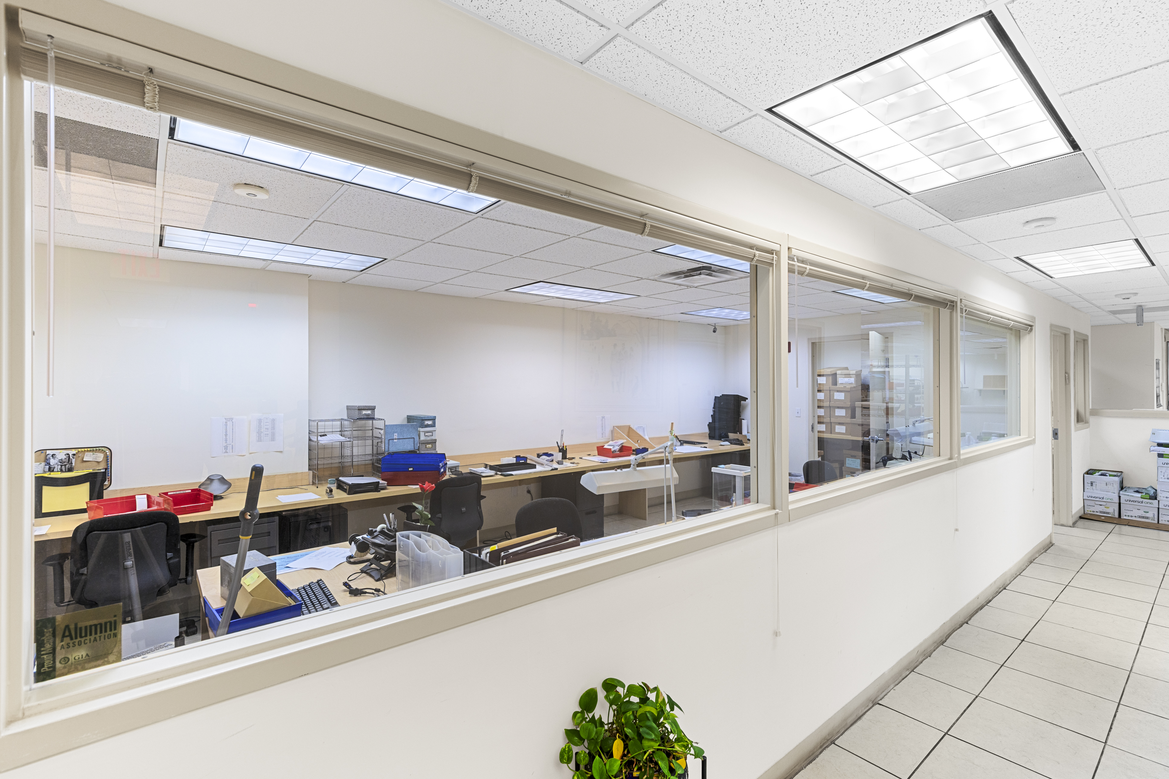 Windowed corridor overlooking workroom
