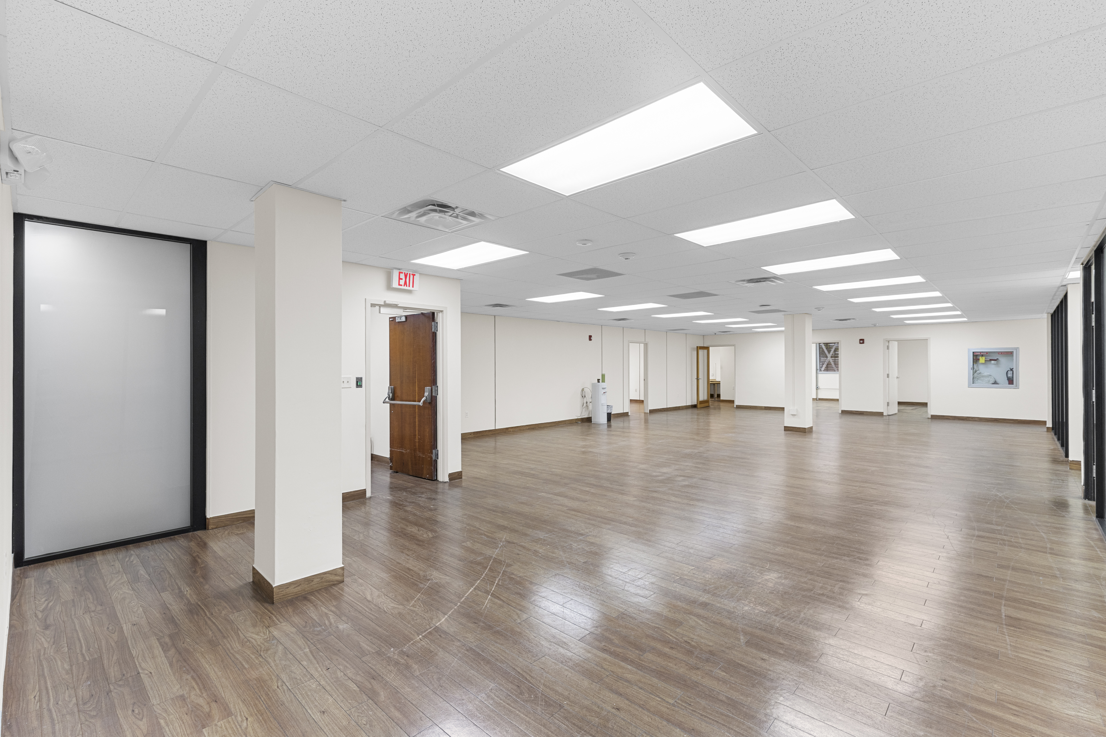 Open floor plan with frosted glass offices